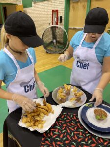 Children plating food for cooking competition